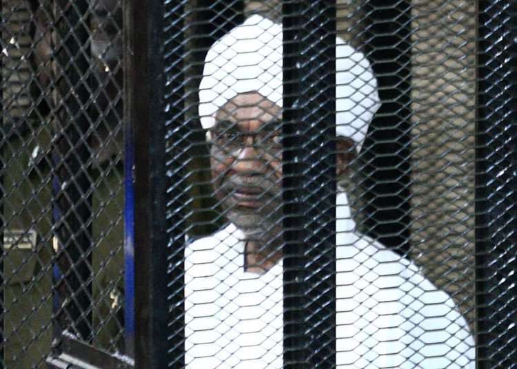 Sudan’s ex-President Omar al-Bashir on trial: over 1989 military coup 1 (FILES) In this file photo taken on August 31, 2019, Sudan’s ex-president Omar al-Bashir appears in court in the capital Khartoum to face charges of illegal acquisition and use of foreign funds. – Sudan’s former president, ousted amid a popular pro-democracy uprising last year, went on trial on July 21, 2020 over the military coup that brought him to power more than three decades ago. It is the first time in the modern history of the Arab world that the architect of a coup goes on trial. Bashir, 76, could face the death penalty if convicted over the 1989 Islamist-backed overthrow of the democratically elected government of prime minister Sadek al-Mahdi. (Photo by Ebrahim HAMID / AFP)