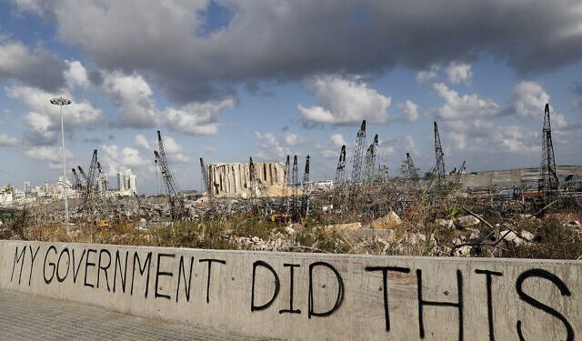 Words are written by Lebanese citizens in front of the scene of the explosion in Beirut, Lebanon .Image Credit: AP Photo/Hussein Malla