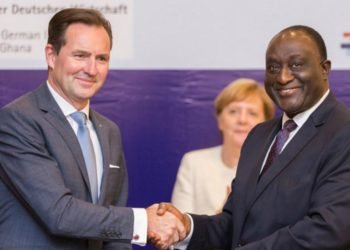 Thomas Schaefer, left, head of VW's sub-Saharan region, is pictured in 2018 with Alan Kyeremanteng, Ghana's Minister of Trade and Industry, at a signing ceremony to expand the automaker's business in the country. German Chancellor Angela Merkel is shown in the background.