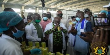 President Akufo-Addo sipping a product of the Ekumfi fruits and juice factory