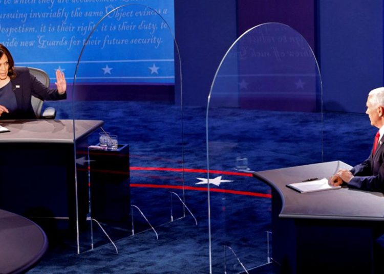 Pence and Harris clash in VP debate 1 Mr Pence and Ms Harris were separated by plexiglass barriers during debate. Image: Reuters
