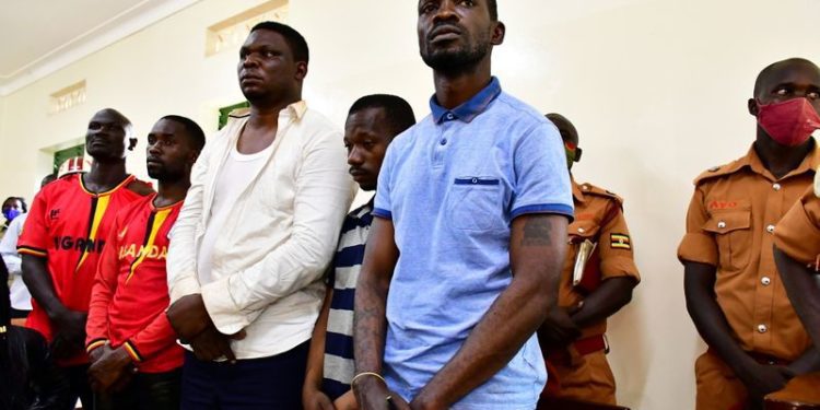Uganda: Bobi Wine released on bail as protest death toll rises to 37 1 Ugandan presidential candidate Robert Kyagulanyi also known as Bobi Wine stands inside the courtroom in Iganga, eastern Uganda. Image: REUTERS