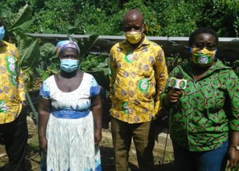 Mrs Amekudzi (Right) with some staff of Mondelez, and a female cocoa farmer