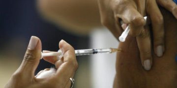 A person is being vaccinated against yellow fever