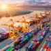World trade volume rallies in Q3 after COVID-19 shock 11 Logistics and transportation of Container Cargo ship and Cargo plane with working crane bridge in shipyard at sunrise, logistic import export and transport industry background