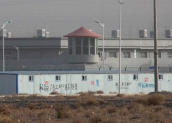 A guard tower and barbed wire fences around a facility in Artux in western China's Xinjiang region