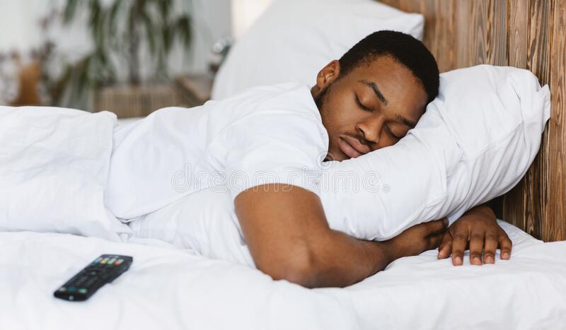 fast asleep black man sleeping embracing pillow resting home fast asleep black man sleeping embracing pillow resting bed 196761565