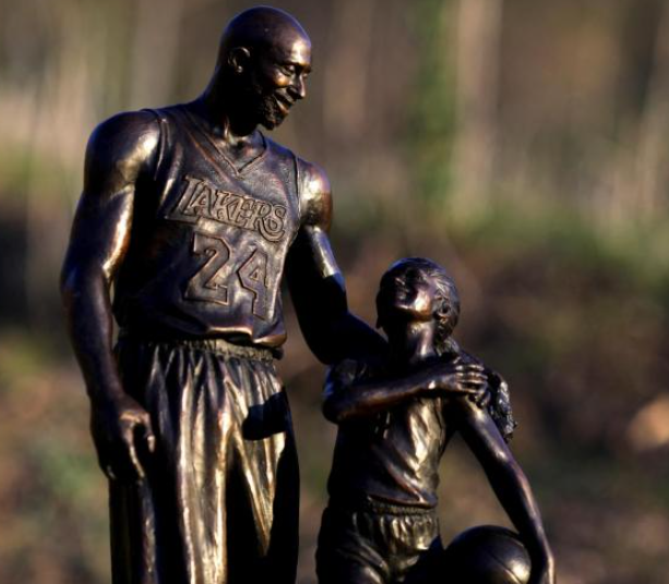 Statue of Kobe and Gigi Bryant Placed at Crash Site on Anniversary 1 A sculpture of NBA great Kobe Bryant and his daughter Gianna "Gigi" Bryant was brought on Wednesday to the helicopter crash site where they perished alongside seven others on a hillside near Los Angeles two years ago.