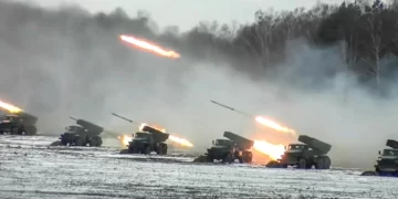 This image from the Russian defence ministry dated February 4 shows rocket launchers firing on a snow-covered field during joint exercises with Belarus (Photo by Handout/Russian defence ministry/AFP)