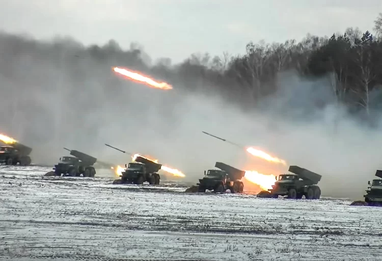 This image from the Russian defence ministry dated February 4 shows rocket launchers firing on a snow-covered field during joint exercises with Belarus (Photo by Handout/Russian defence ministry/AFP)