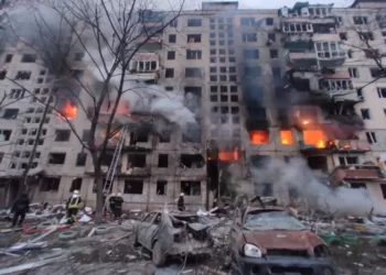 In this handout picture taken and released by the State Emergency Service of Ukraine on March 14, 2022, firefighters work to extinguish a fire in an apartment building hit by shelling in the Obolon district of Kyiv