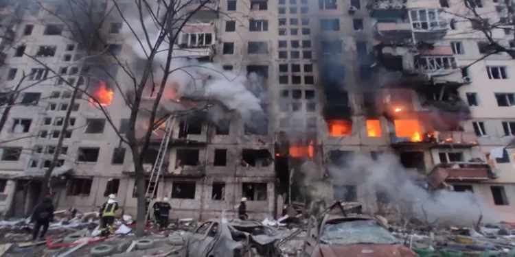 In this handout picture taken and released by the State Emergency Service of Ukraine on March 14, 2022, firefighters work to extinguish a fire in an apartment building hit by shelling in the Obolon district of Kyiv