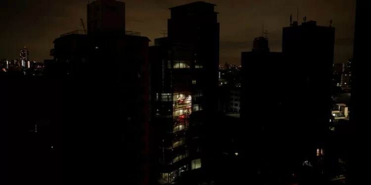 Houses and buildings are seen in an electric stoppage at the area after an earthquake at Toshima ward in Tokyo, Japan March 17, 2022.