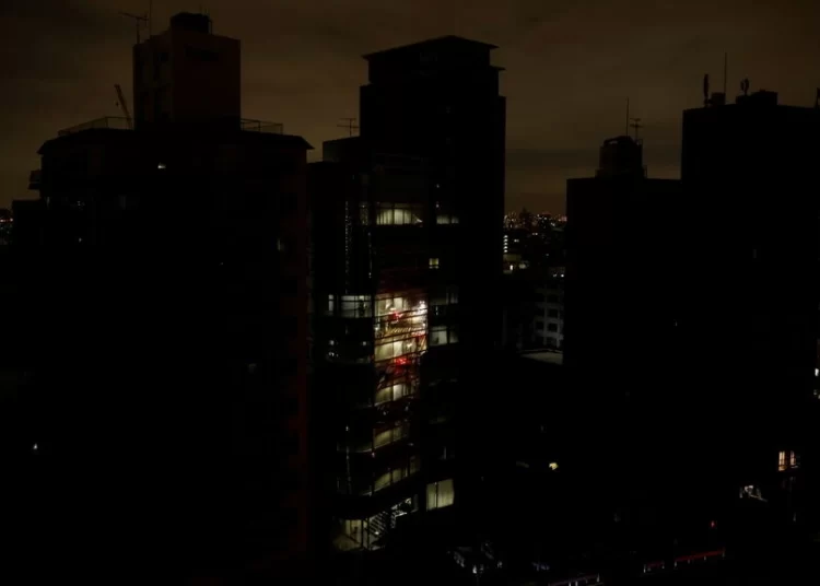 Houses and buildings are seen in an electric stoppage at the area after an earthquake at Toshima ward in Tokyo, Japan March 17, 2022.