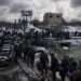 Ukrainians cross an improvised path under a destroyed bridge while fleeing Irpin, in the outskirts of Kyiv, Ukraine, Tuesday, March 8, 2022