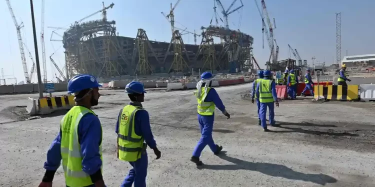 Construction workers heading towards a world cup stadium site.
