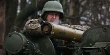 Ukrainian soldier stands guard close to the front line with Russian troops near Kharkiv