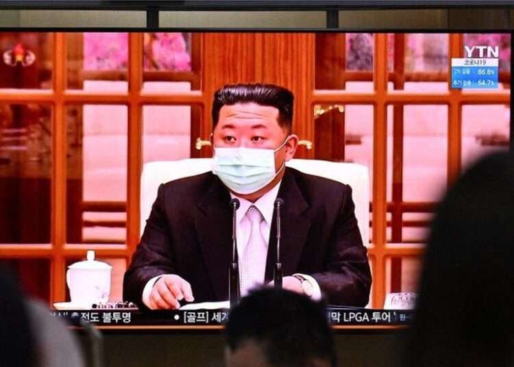 North Korean leader Kim Jong Un appeared in a face mask on television for the first time on Thursday to order nationwide lockdowns