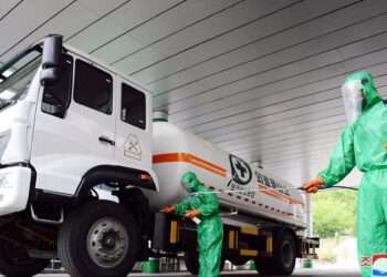 A worker disinfects a vehicle carrying medical oxygen, in Pyongyang