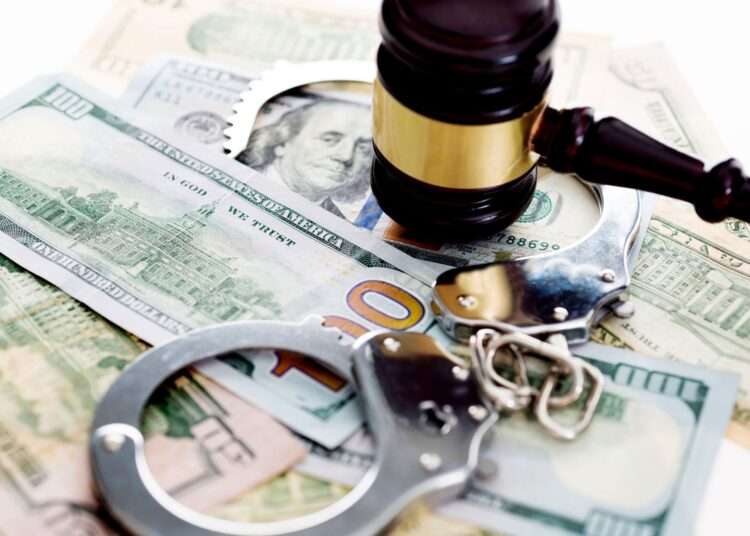 SEC Issues New Directive to Toughen Stance on Anti-money Laundering Fight 1 judges gavel and handcuffs on american dollars 636192812 5b0bac1b7f8f4bcfbe25126a0b79bb4e