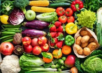 Food background with assortment of fresh healthy organic fruits and vegetables on the table