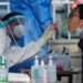 China Begins Implementing Relaxed Anti-COVID-19 Measures 15 A resident being vacinated