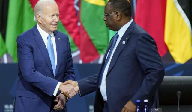 President Joe Biden shakes hands with Senegal's President Macky Sall, chair of the African Union