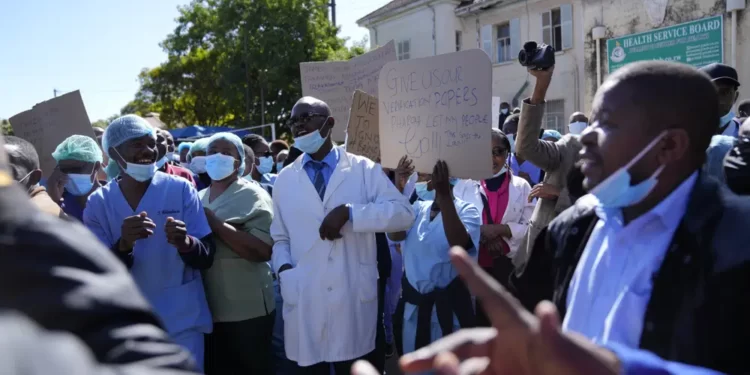 Health workers led by nurses take part in a demonstration over poor salaries at Parirenyatwa Hospital in Harare on June, 21, 2022.
