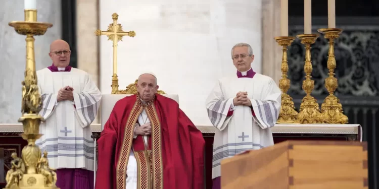 Pope Francis sits by the coffin of late Pope Emeritus Benedict XVI St. Peter's Square during a funeral mass at the Vatican, Thursday, Jan. 5, 2023