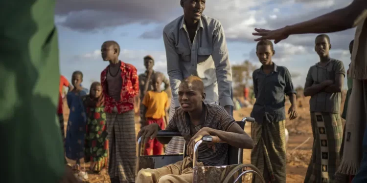 Displaced people who have arrived at a camp wait for plot allocation on the outskirts of Dollow, Somalia.