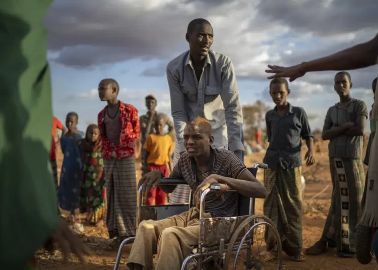 Displaced people who have arrived at a camp wait for plot allocation on the outskirts of Dollow, Somalia.