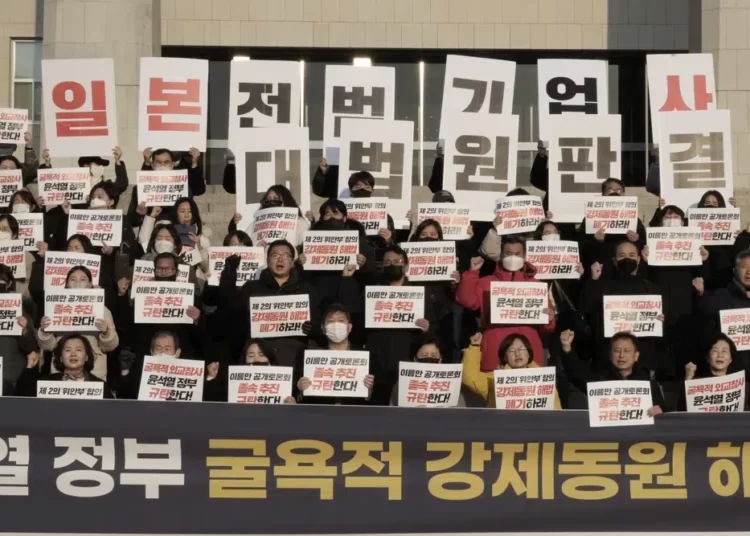 South Korea Considers Setting Up Funds To Compensate Forced Labor Victims 1 Members of a civic group seeking compensation from Japanese firms over forced labor during World War II and opposition lawmakers stage a rally to oppose the government's reported resolution to the issue outside the National Assembly in Seoul, Thursday, Jan. 12, 2023. The banners read "Apology and compensation from Japanese war criminal companies and condemn the government of President Yoon Suk Yeol."