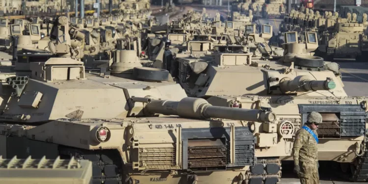 A soldier walks past a line of M1 Abrams tanks, Nov. 29, 2016, at Fort Carson in Colorado Springs