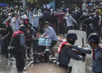 Protesters run after police shot warning shots and used water cannon to disperse them during a protest in Mandalay, Myanmar on Feb. 9, 2021.