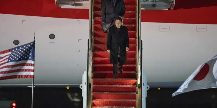 Japanese Prime Minister Fumio Kishida walks down the steps as he arrives at Andrews Air Force Base
