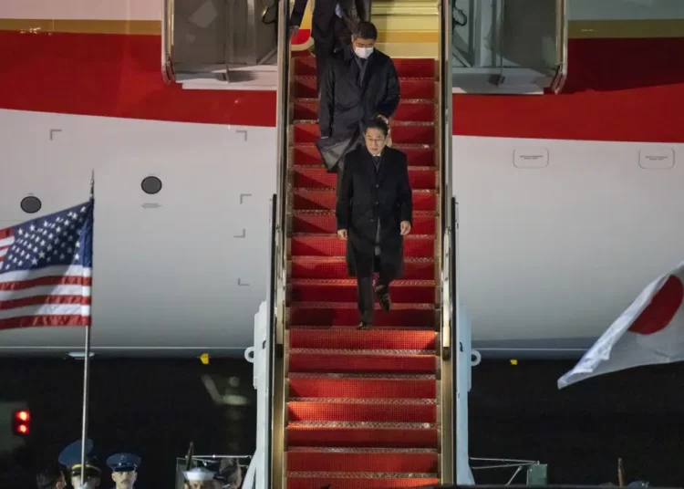 Japanese Prime Minister Fumio Kishida walks down the steps as he arrives at Andrews Air Force Base