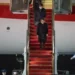 Japanese Prime Minister Fumio Kishida walks down the steps as he arrives at Andrews Air Force Base
