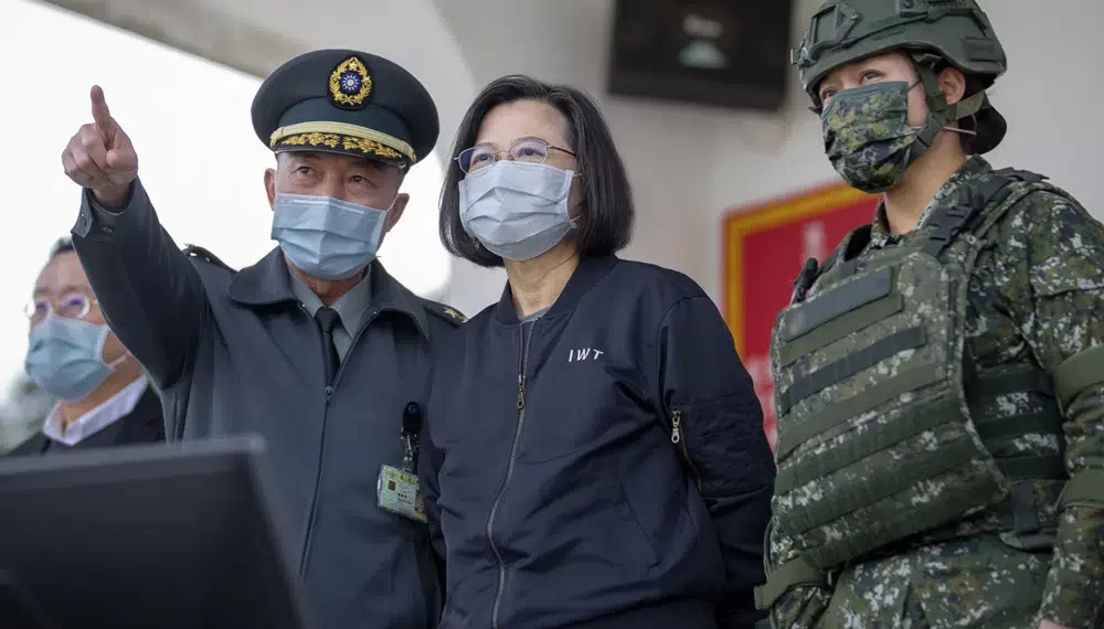 In this photo released by the Taiwan Presidential Office, Taiwan's President Tsai Ing-wen, center, inspects a military drills at a military base in Chiayi, southwestern Taiwan, Friday, Jan. 6, 2023.