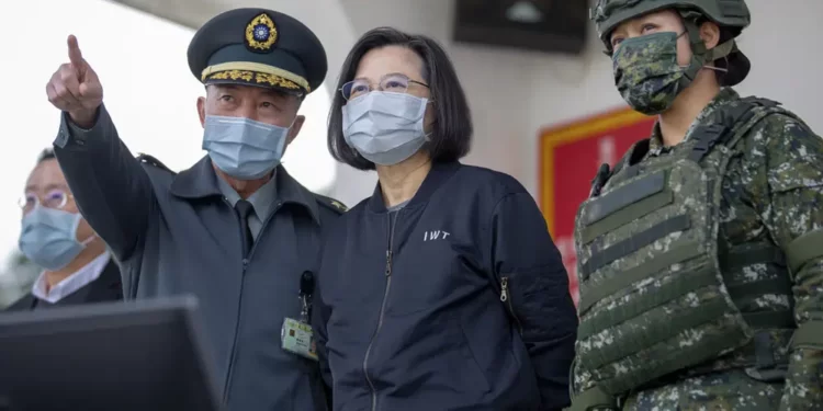In this photo released by the Taiwan Presidential Office, Taiwan's President Tsai Ing-wen, center, inspects a military drills at a military base in Chiayi, southwestern Taiwan, Friday, Jan. 6, 2023.