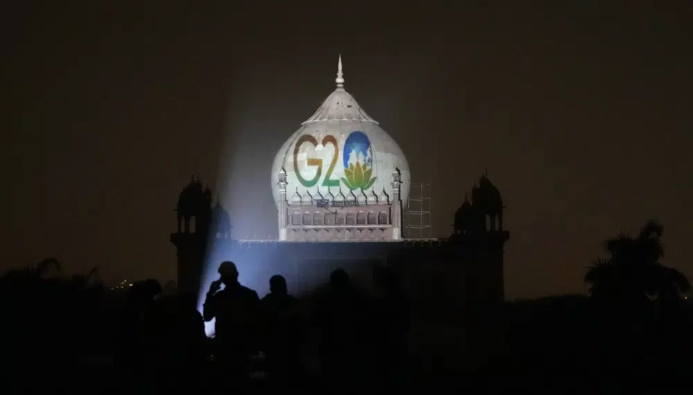 Archaeological Survey of India workers project the logo of G20 on to Safdarjung's tomb to mark India's presidency of G20, in New Delhi, Thursday, Dec. 1, 2022.