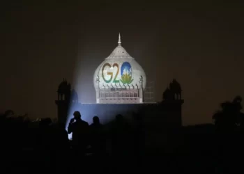 Archaeological Survey of India workers project the logo of G20 on to Safdarjung's tomb to mark India's presidency of G20, in New Delhi, Thursday, Dec. 1, 2022.