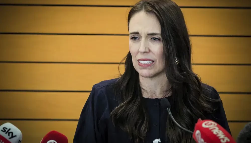 New Zealand Prime Minister Jacinda Ardern grimaces as she announces her resignation at a press conference in Napier, New Zealand