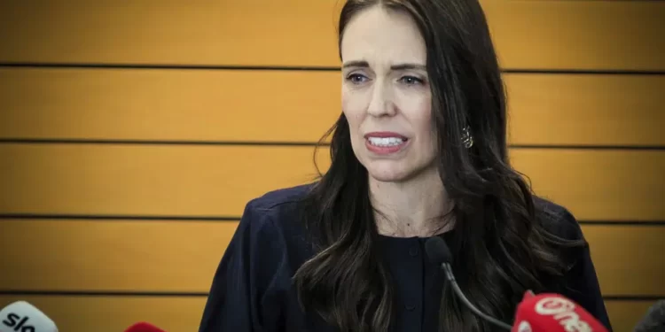 New Zealand Prime Minister Jacinda Ardern grimaces as she announces her resignation at a press conference in Napier, New Zealand