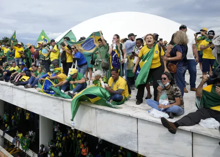 <strong>Investigations Start After Bolsonaro Supporters Storm Congress</strong> 1 supporters of Brazil's former President Jair Bolsonaro, stand on the roof of the National Congress building