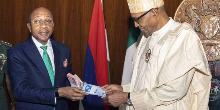 In this photo released by the Nigeria State House, Nigeria's central bank governor, Godwin Emefile, left, presents the newly designed currency notes to Nigeria's President Muhammadu Buhari, right, during a launch in Abuja, Nigeria