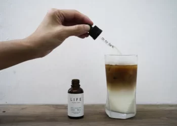 An employee adds drops of water-soluble CBD, or cannabidiol, an essential component of medical marijuana, into a coffee glass at the Found Cafe in Hong Kong on Sept. 13, 2020.