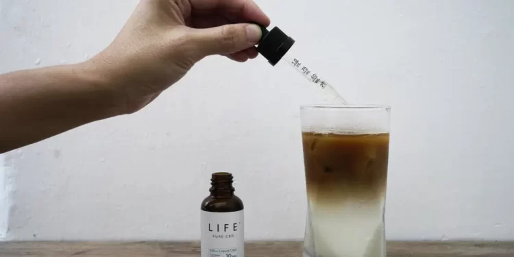 An employee adds drops of water-soluble CBD, or cannabidiol, an essential component of medical marijuana, into a coffee glass at the Found Cafe in Hong Kong on Sept. 13, 2020.