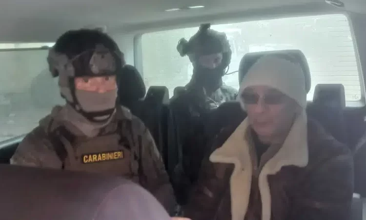 In this Italian Carabinieri handout photo made available on Monday, Jan. 16, 2023, top Mafia boss Matteo Messina Denaro, right, is seen in a car with Italian Carabinieri officers soon after his arrest at a private clinic in Palermo, Sicily.