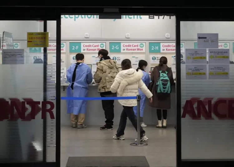 Passengers arriving from China prepare for their coronavirus test at a COVID-19 testing center at the Incheon International Airport In Incheon, South Korea, Tuesday, Jan. 10, 2023.