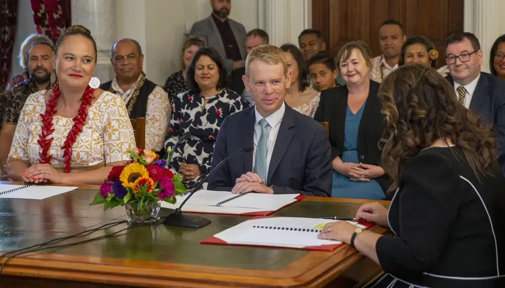 Chris Hipkins, center, is sworn in as New Zealand's next Prime Minister and Carmel Sepuloni, left, as Deputy Prime Minister by Governor-General Dame Cindy Kiro, right, at Government House in Wellington, Wednesday, Jan. 25, 2023